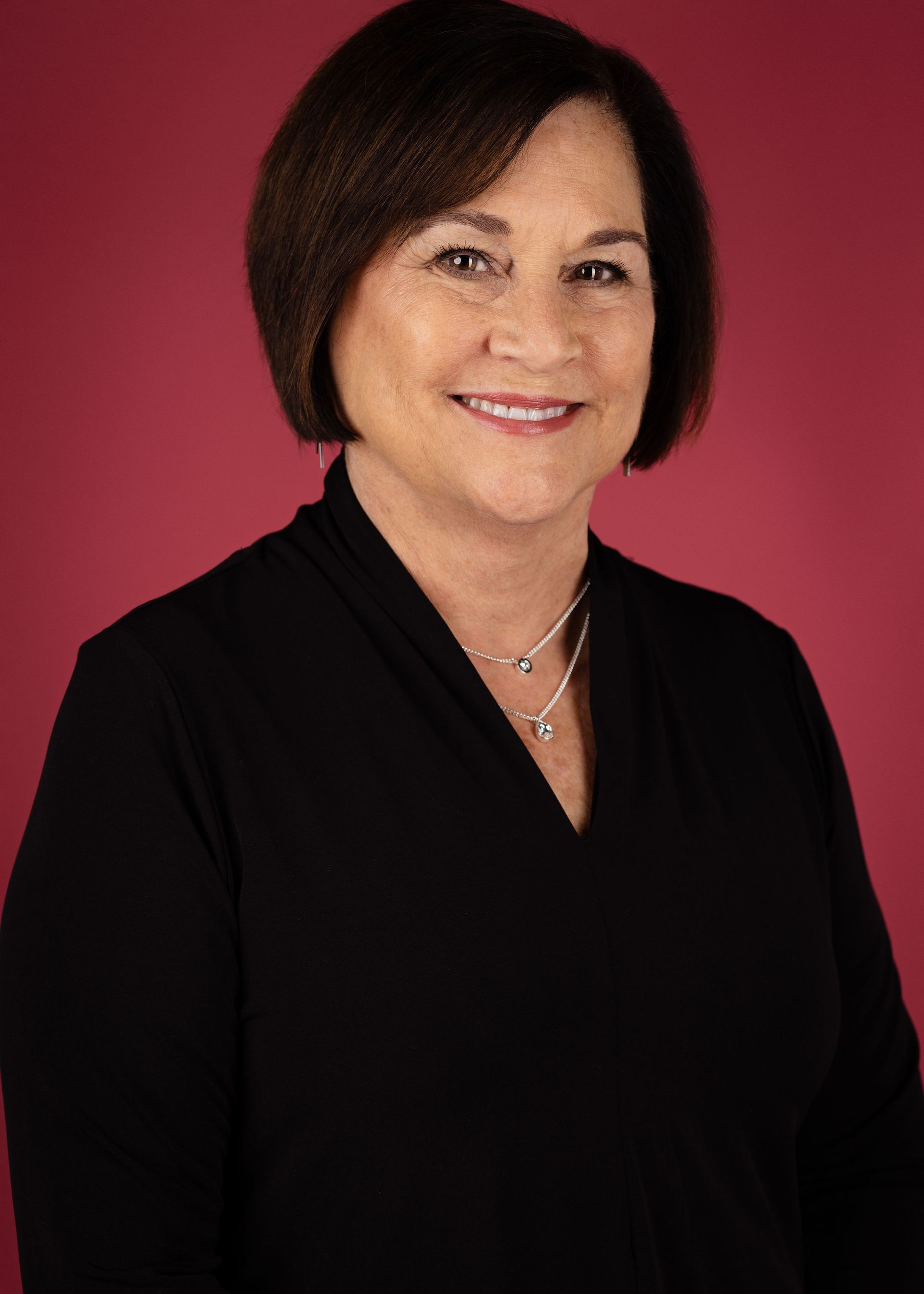 Jocelyn Stridsberg, A woman in a black shirt and necklace is smiling for the camera.