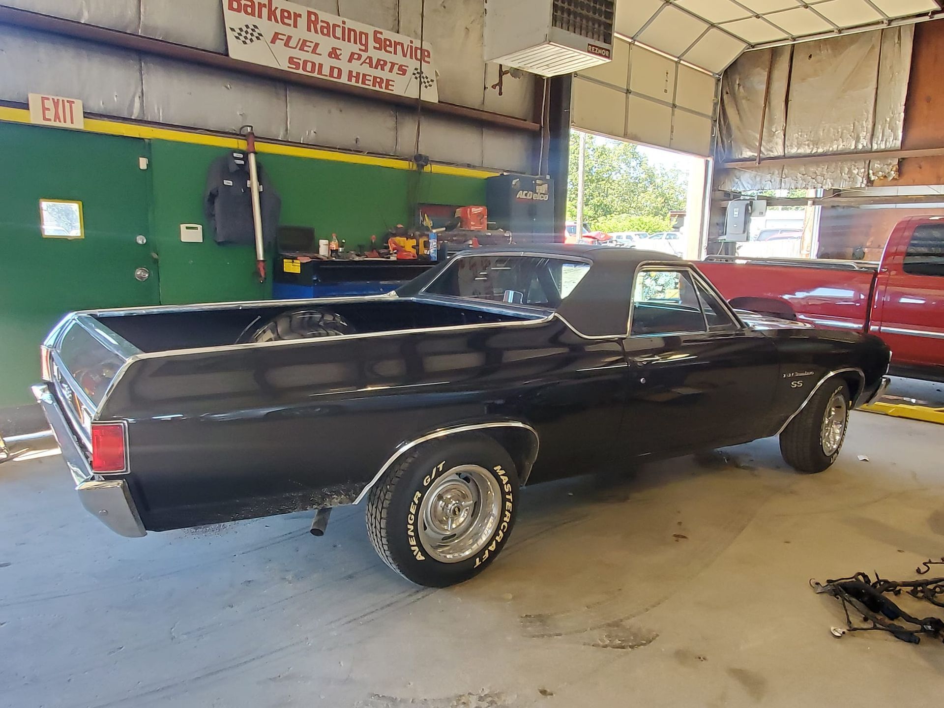 Black El Camino pickup truck inside a garage.
