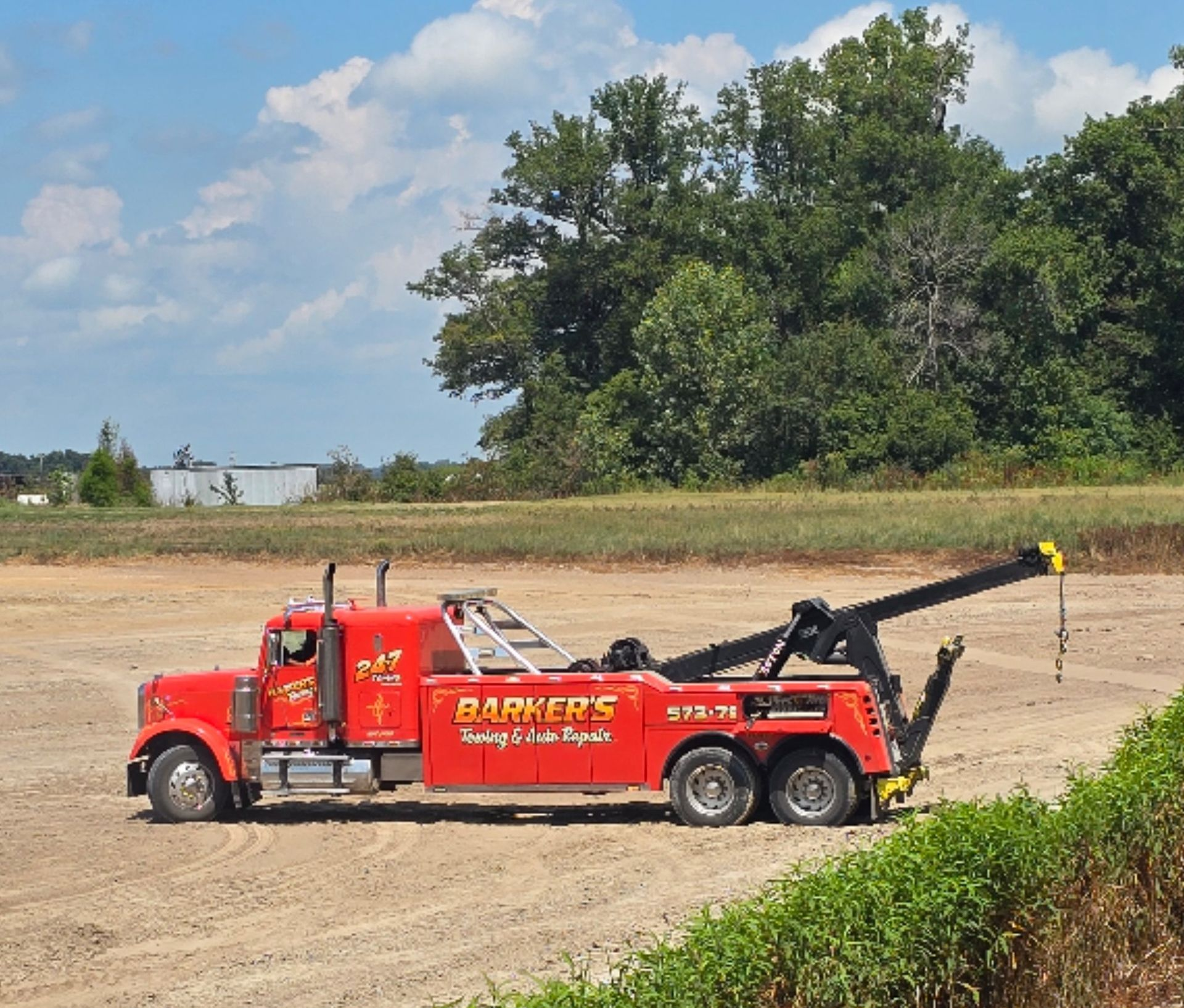 Red tow truck with the name 
