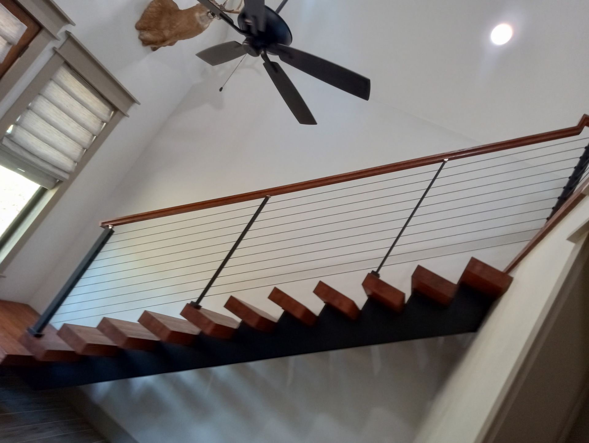 A freshly painted wooden staircase with metal accents.