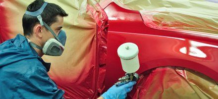 Car body being painted with red