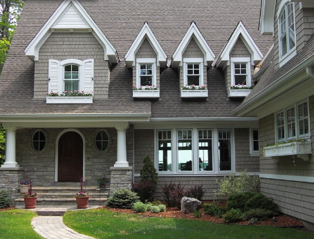 A large house with a lot of windows and shutters