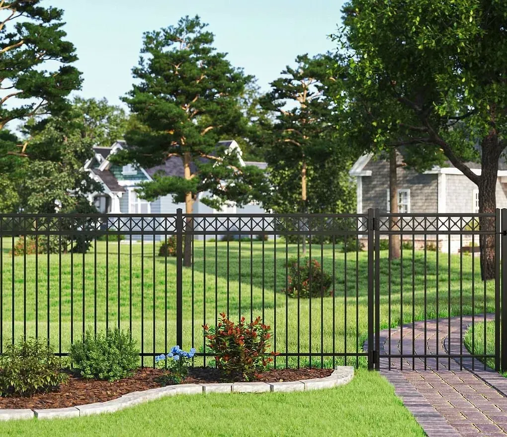 Black metal fence in a landscaped yard with green lawn, trees, and a brick walkway