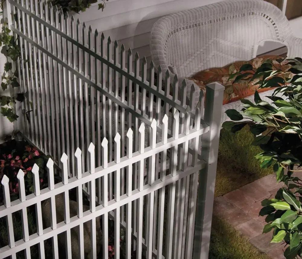 White picket fence enclosing a covered patio with potted plants and garden greenery