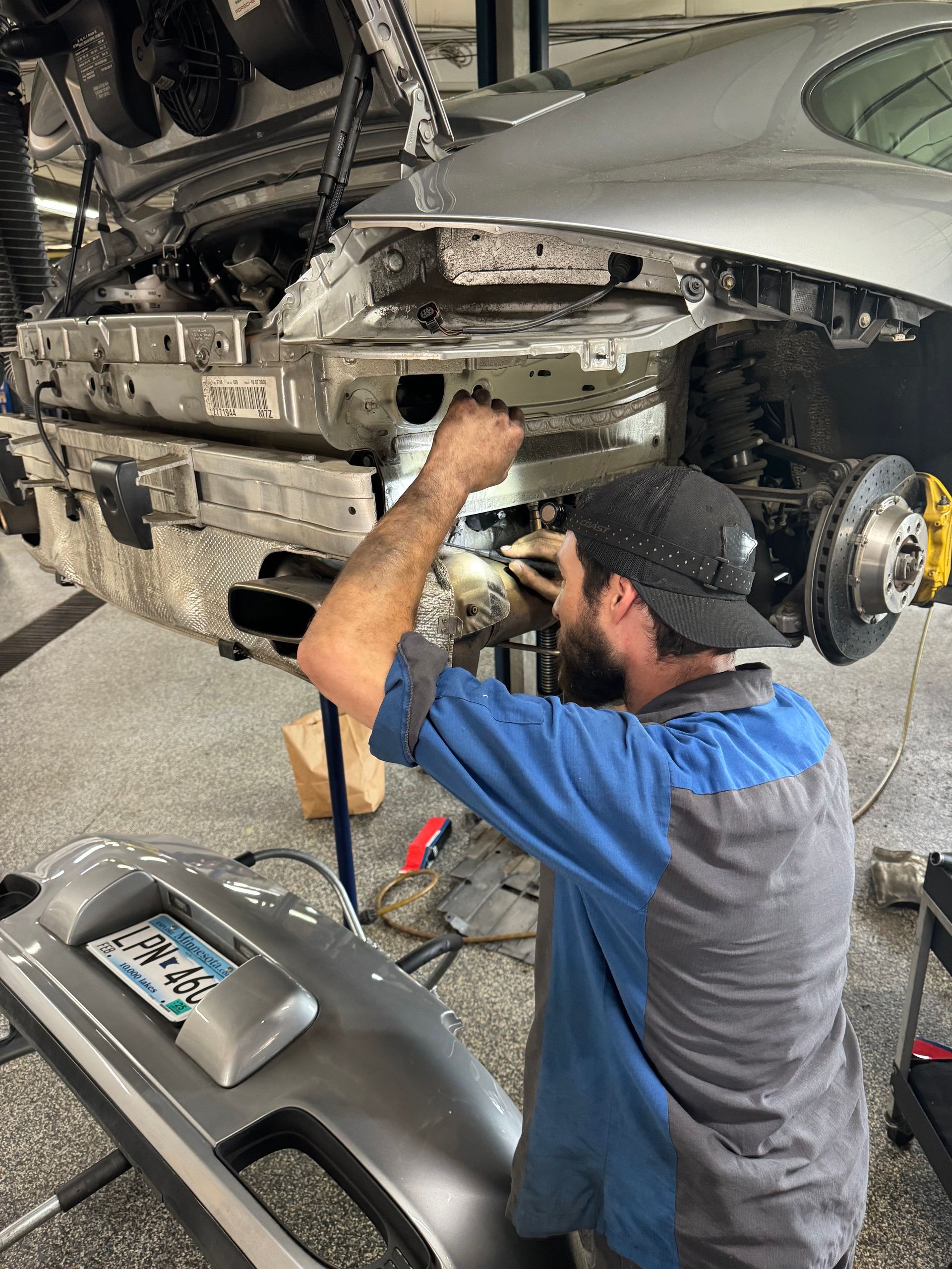 A man is working on a car in a garage.