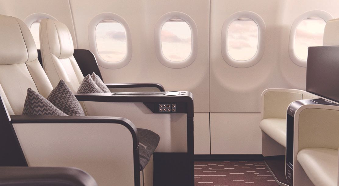 The inside of an airplane with a lot of seats and windows.