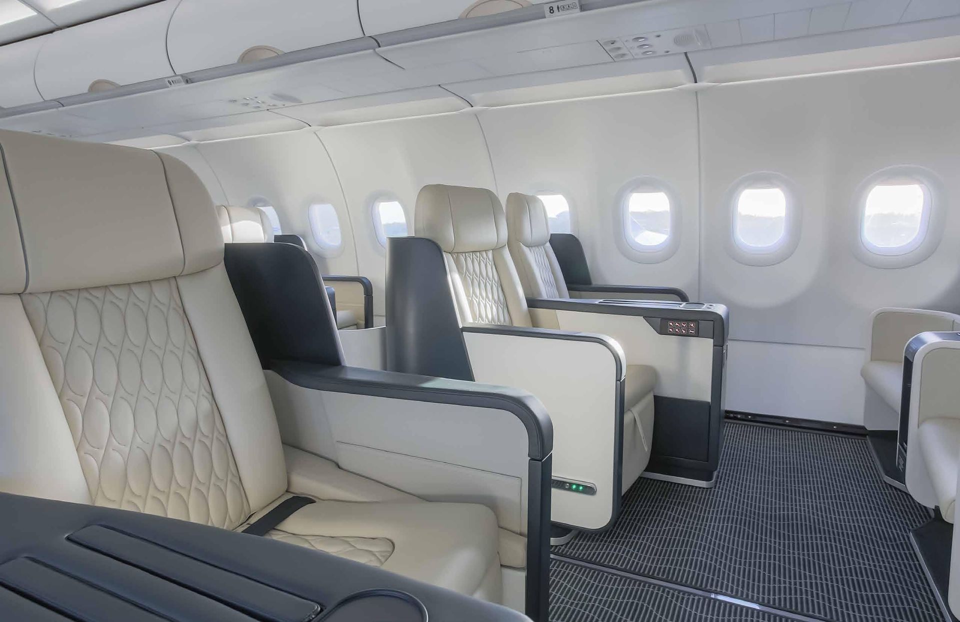 The inside of an airplane with a lot of seats and a table.