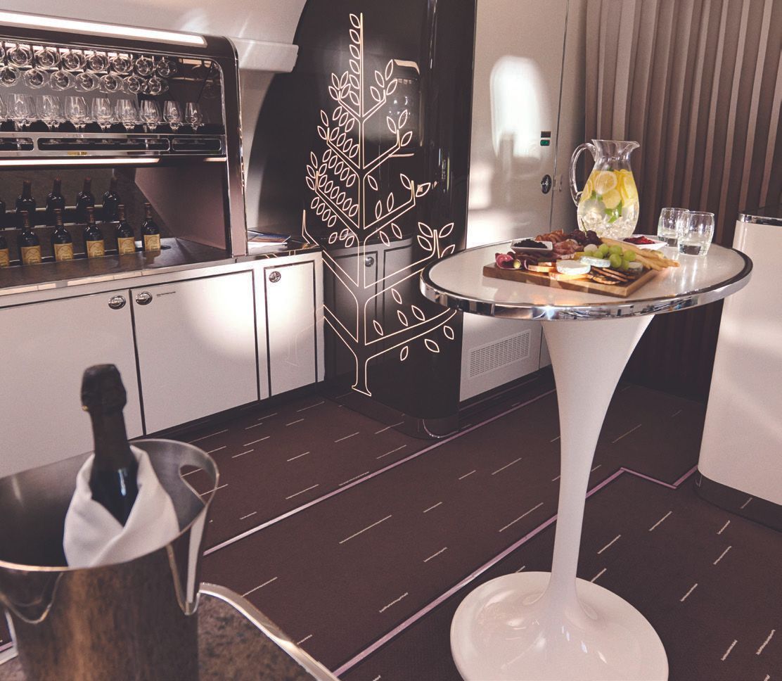 A bucket of champagne sits on a table in a kitchen
