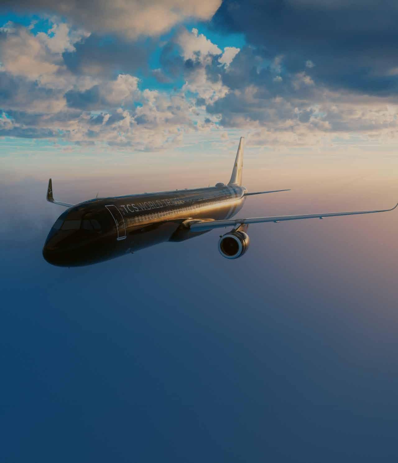 A large passenger jet is flying through a cloudy sky.