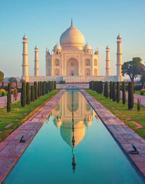 The taj mahal is a very large building with a reflection in the water.