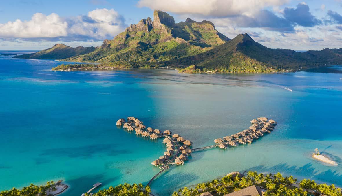 An aerial view of a tropical island in the middle of the ocean.