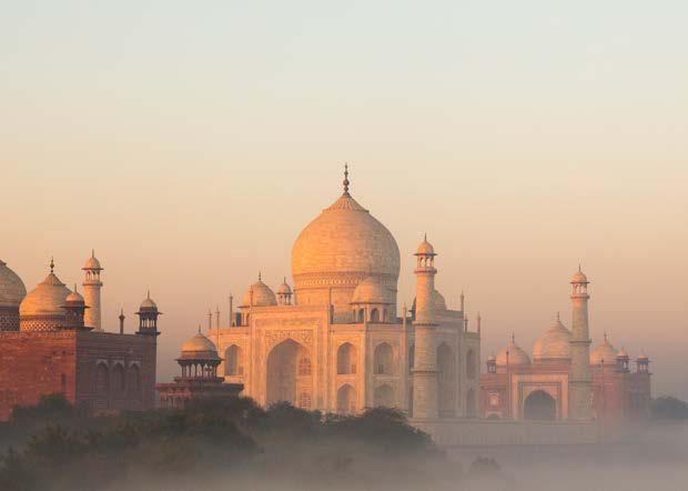 The taj mahal is a very large building with a lot of arches and domes.