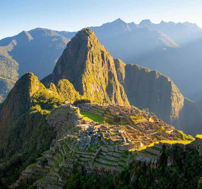 An aerial view of the ruins of machu picchu in the mountains.