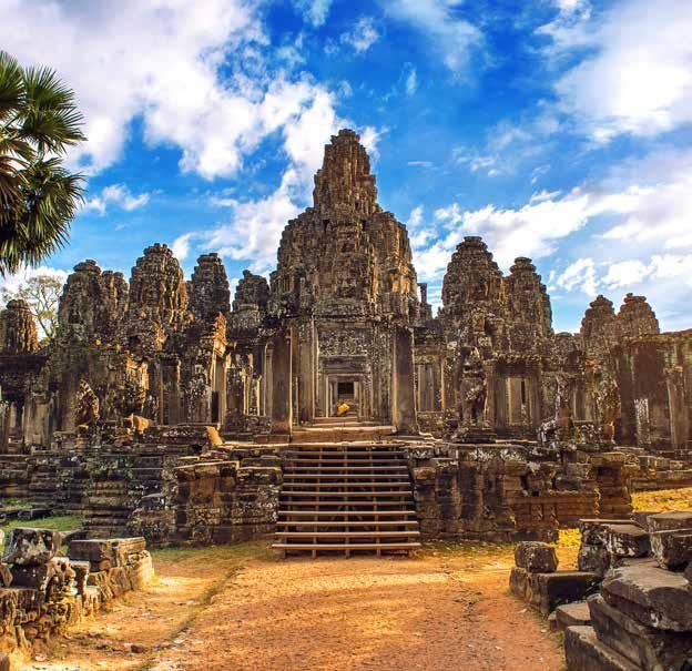 A large stone temple with stairs leading up to it.