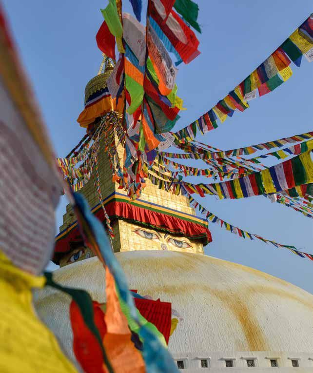 A tower with a lot of colorful flags on it