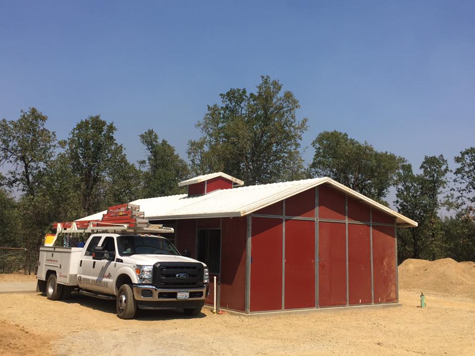 DC Steel Erectors truck next to outside of red steel building