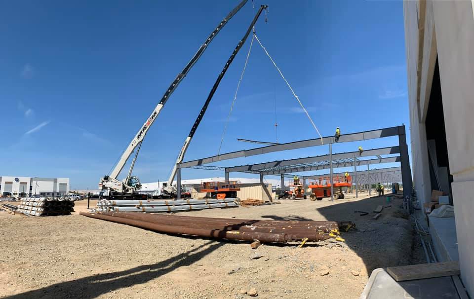 Cranes lowering beams into position 01
