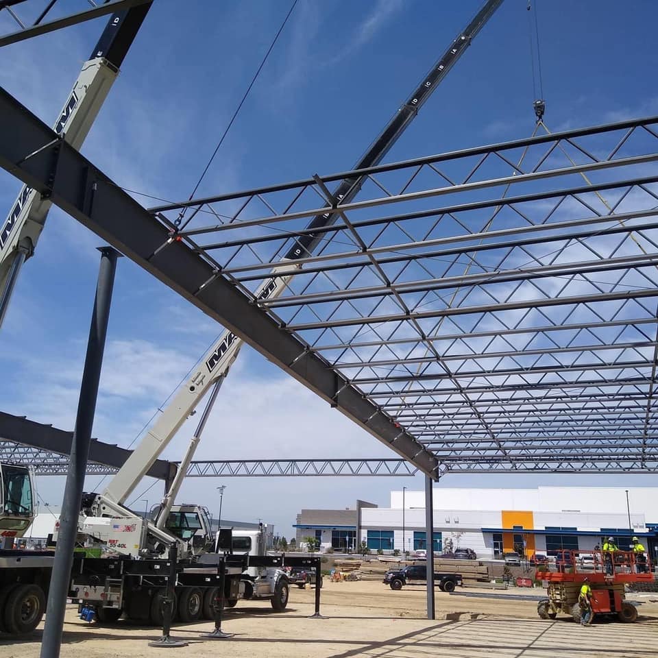 Cranes lowering beams into position 02