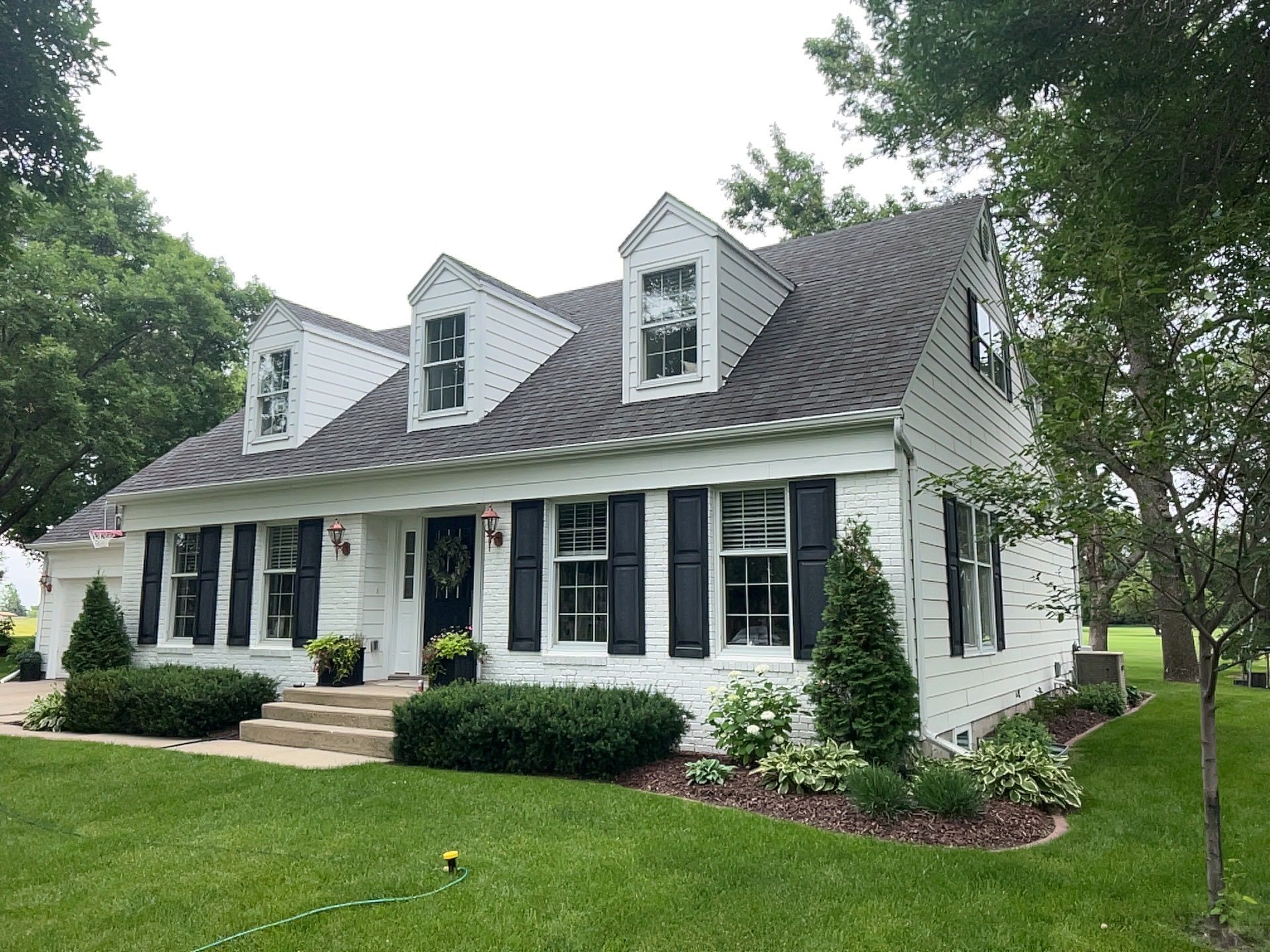 Two men are working on the roof of a house.