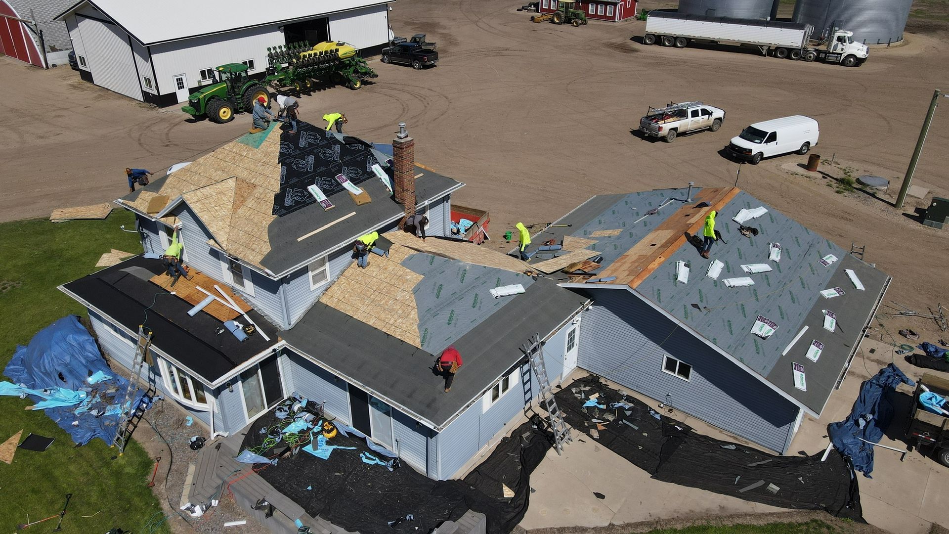A house with a brown roof and white trim