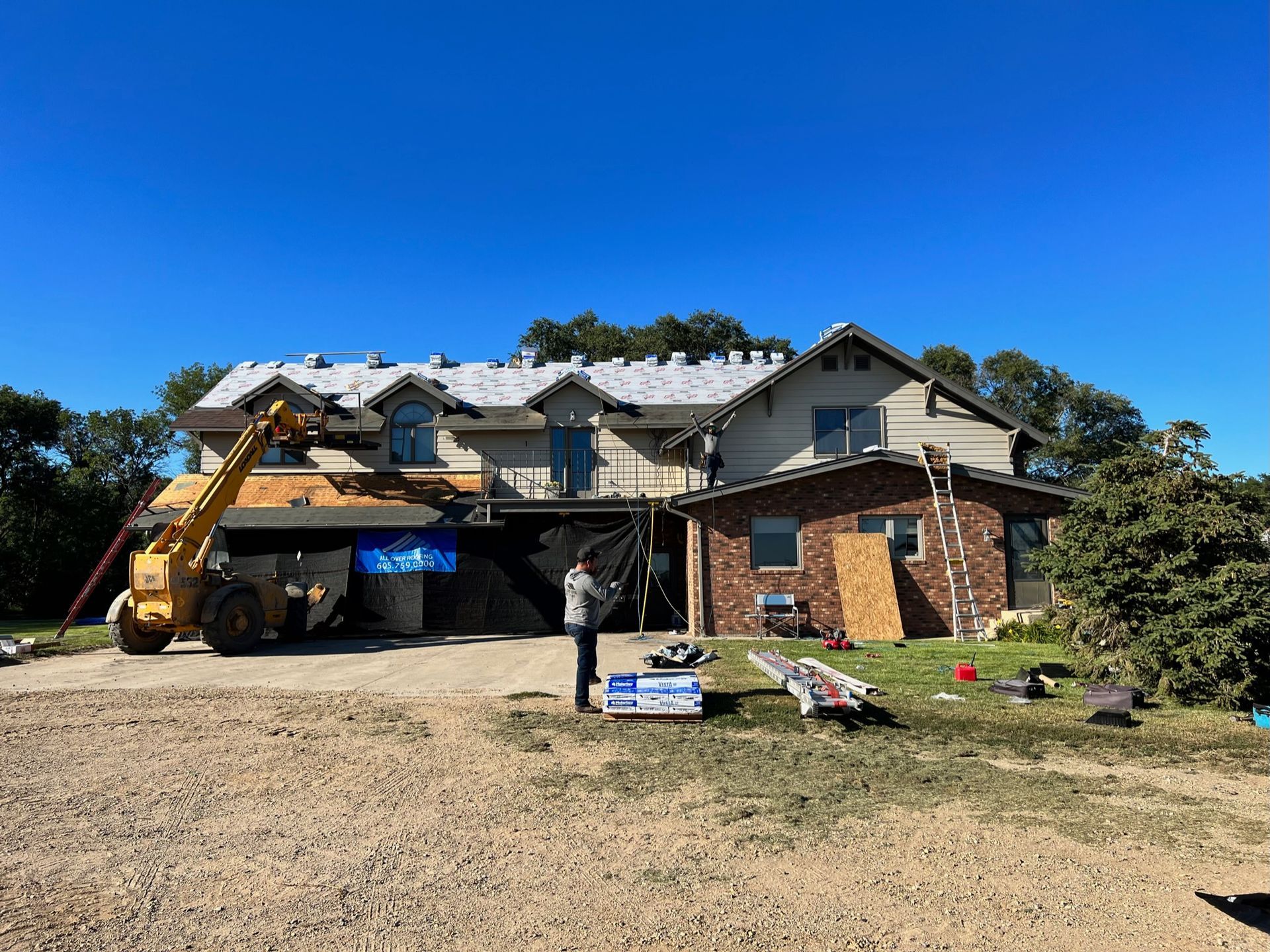 A house with a brown roof and white trim