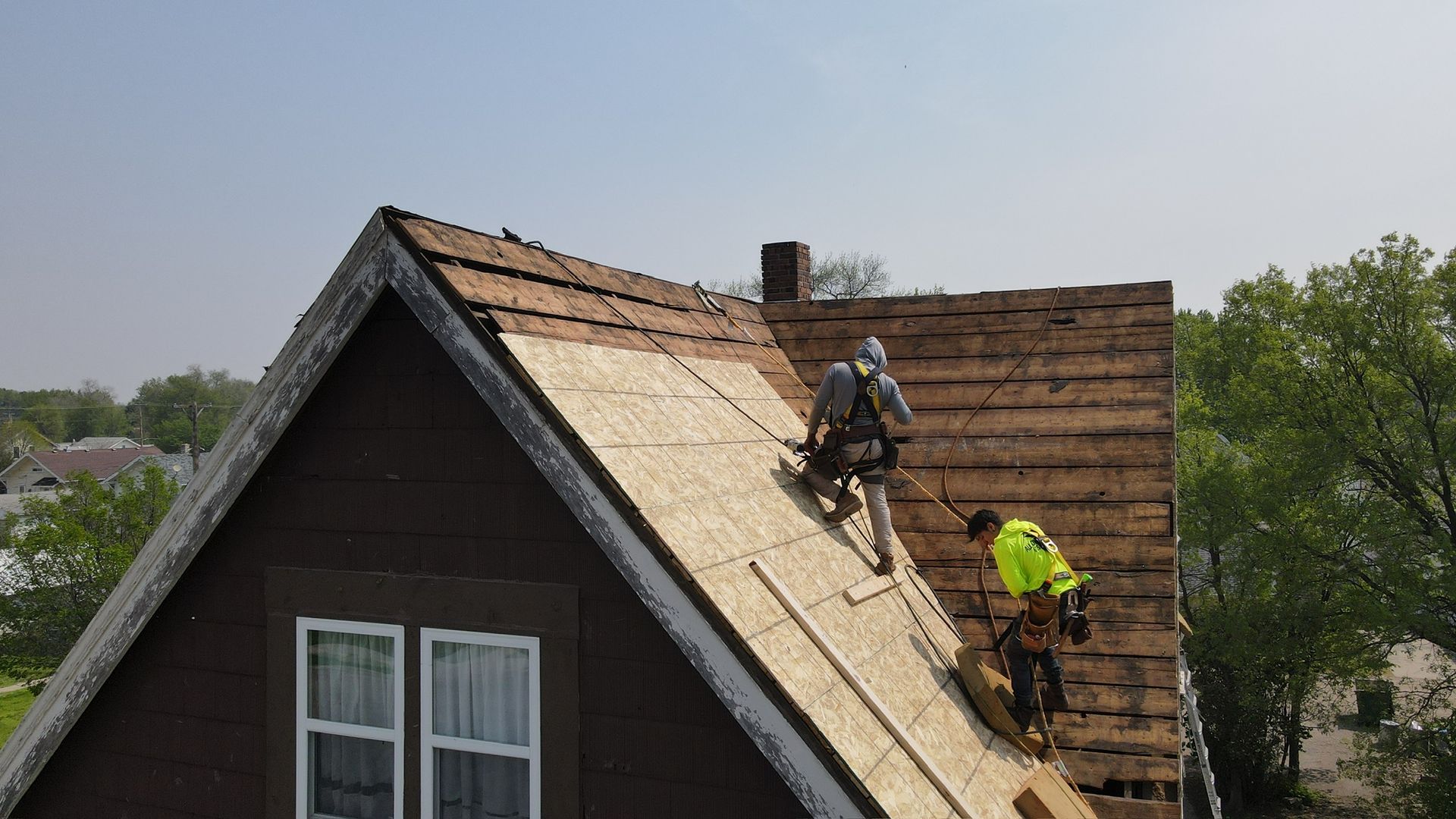 The roof of a house with a blue sky in the background.