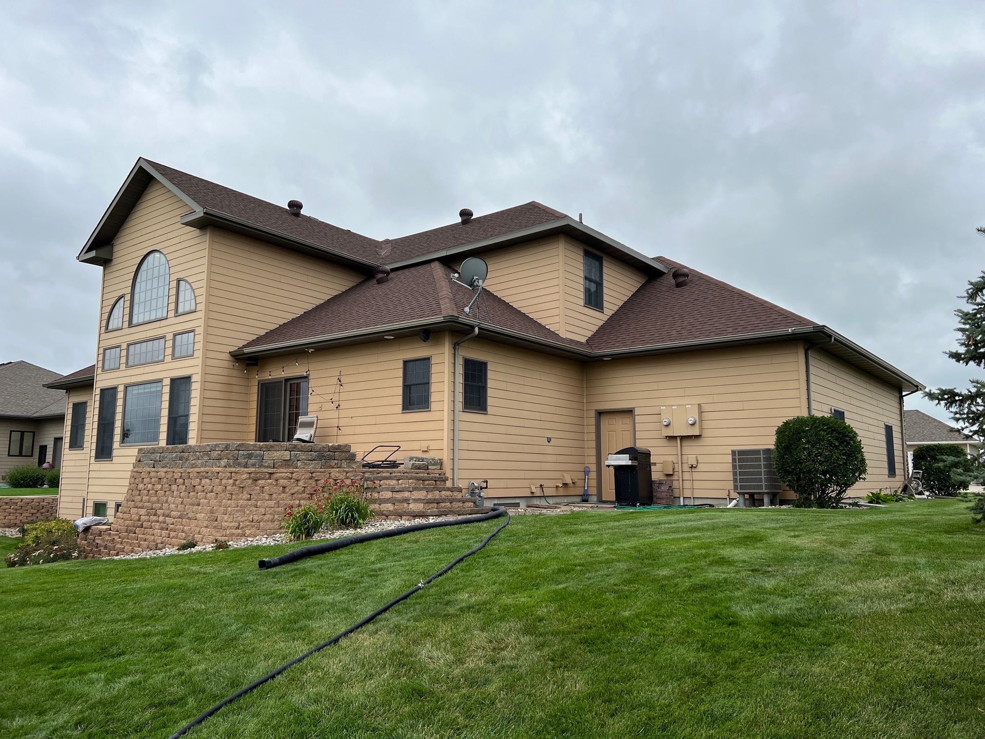 A man is working on a table in an attic.