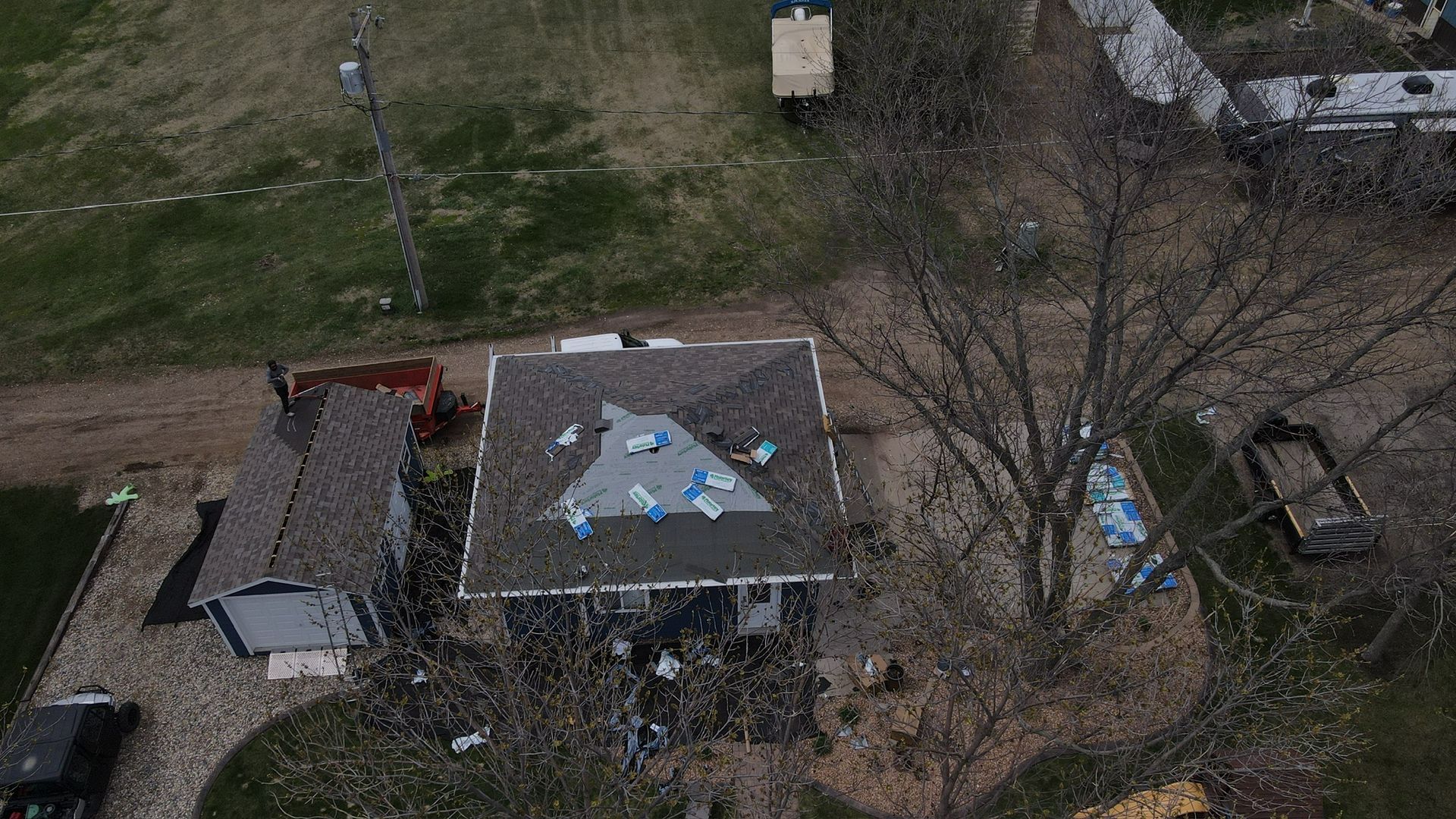 A white house with a gray metal roof