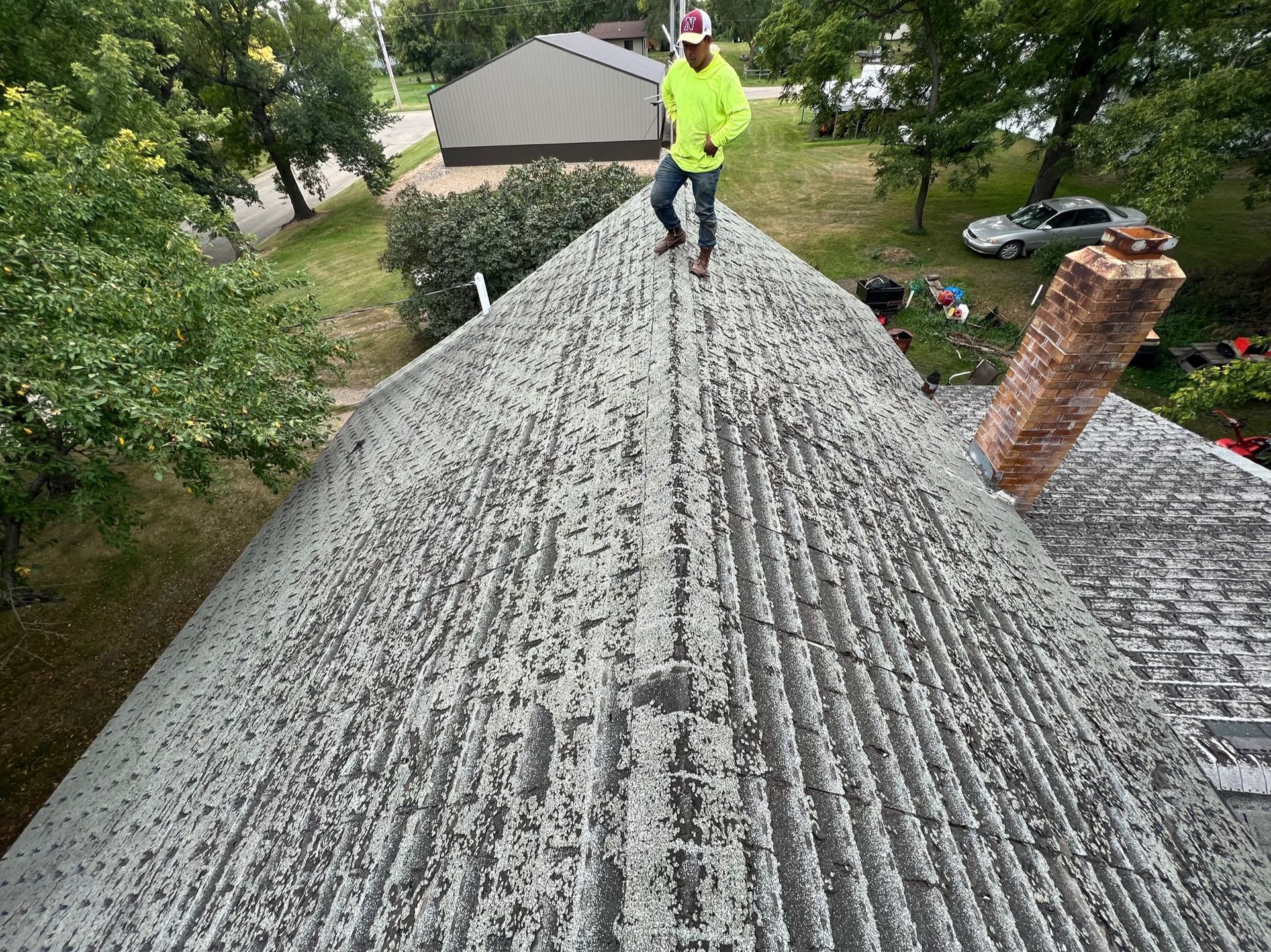 An aerial view of a man working on a roof.