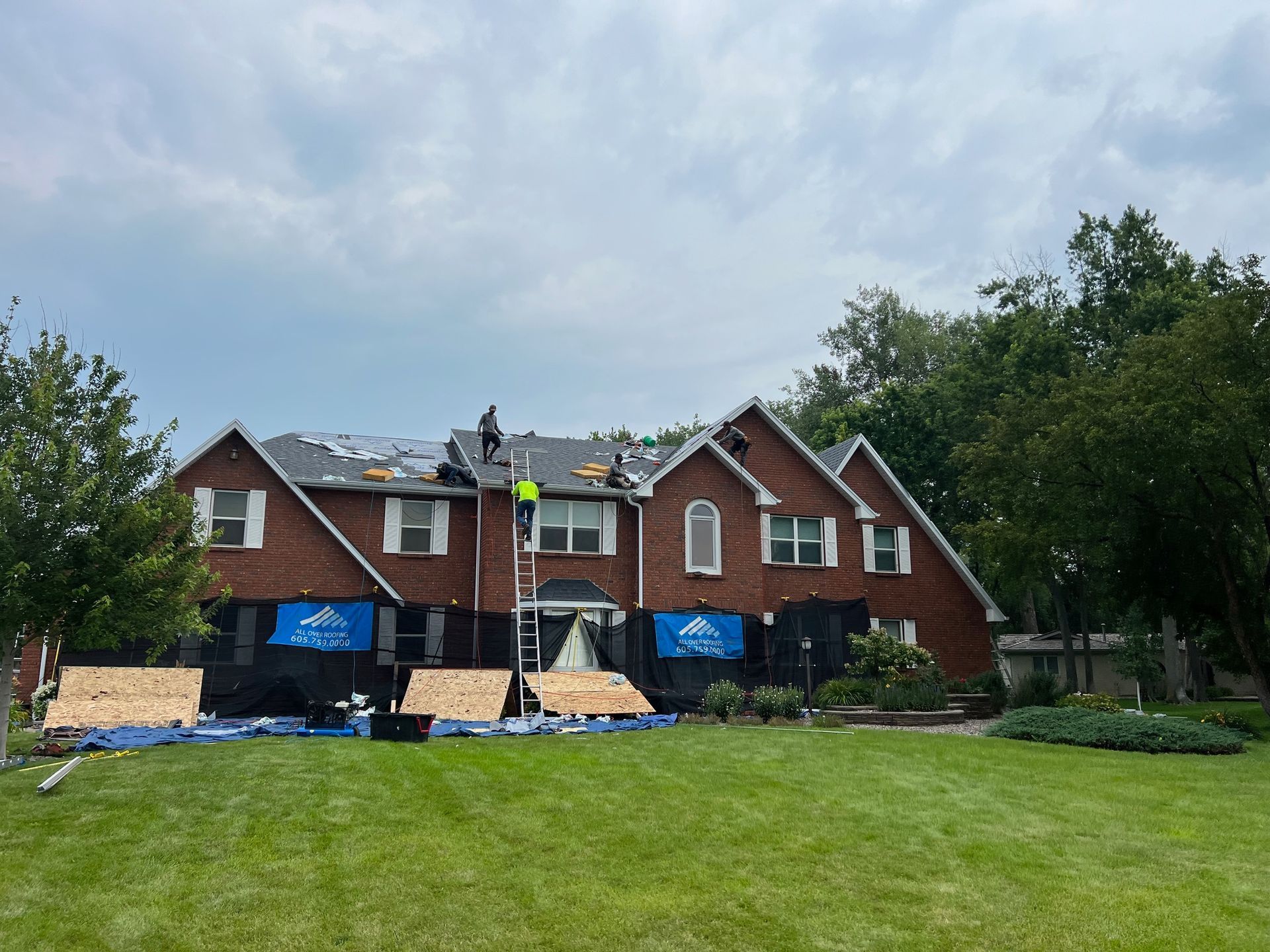 A metal roof is being installed on a house under construction.