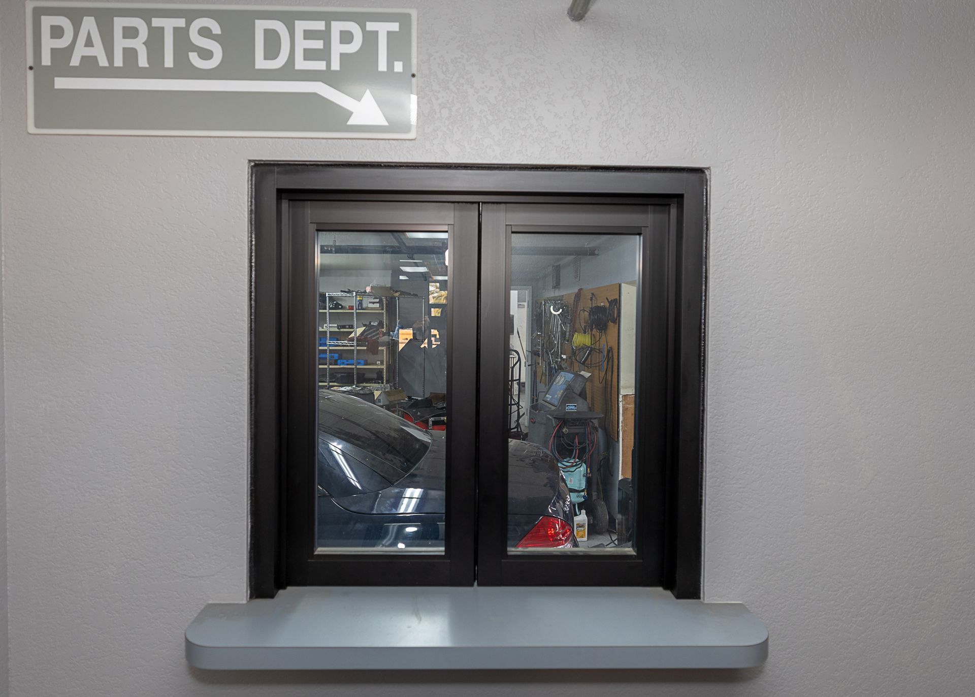 Parts department service window with sign and counter.