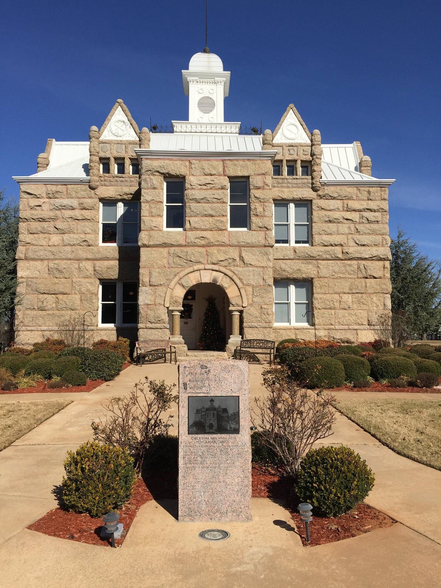 A large stone building with a clock tower on top of it.