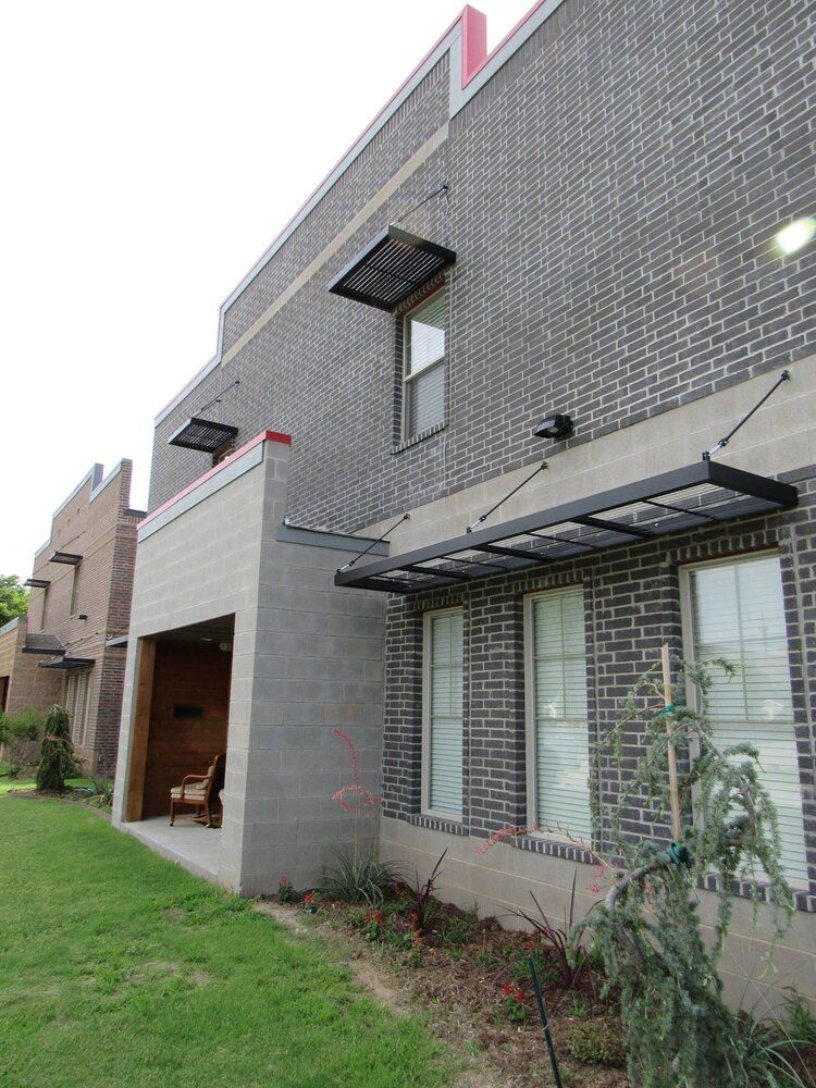A brick building with a canopy on the side of it