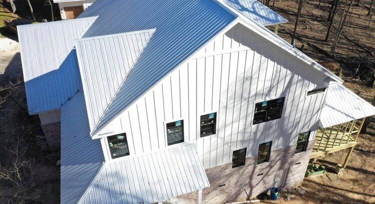 An aerial view of a white house under construction.