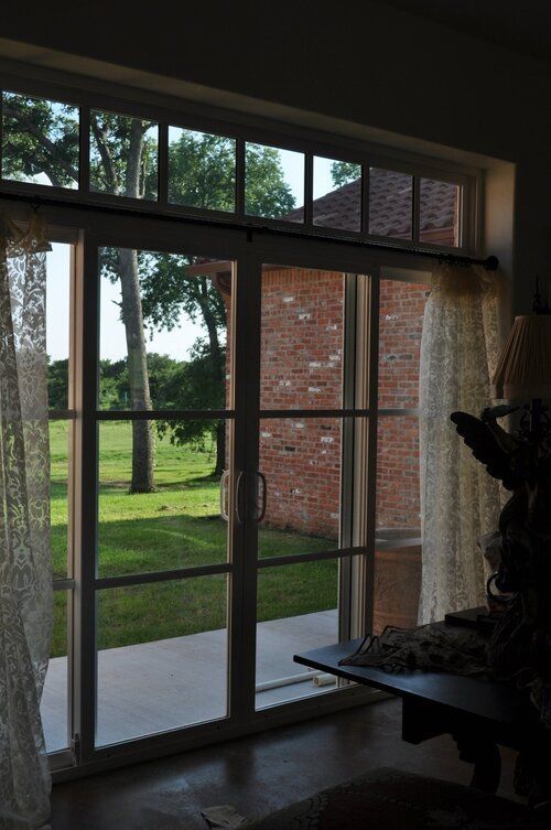 A living room with a sliding glass door leading to a patio