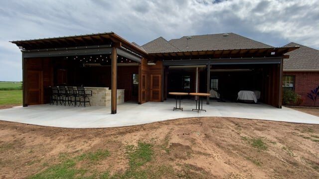 A large house with a large patio in front of it.