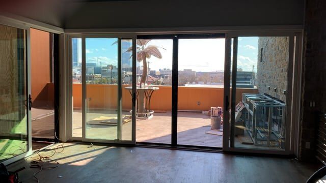 A living room with sliding glass doors leading to a balcony.