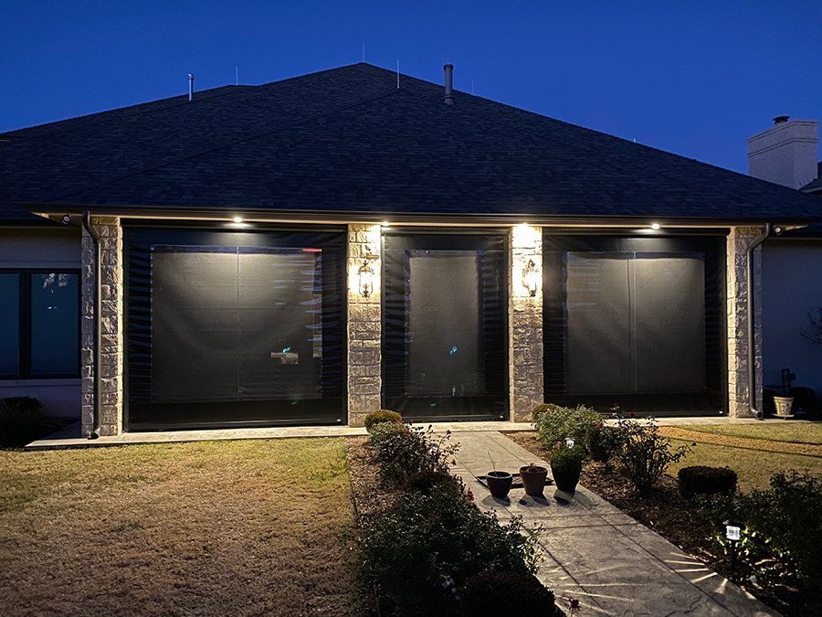 A house with a lot of windows is lit up at night