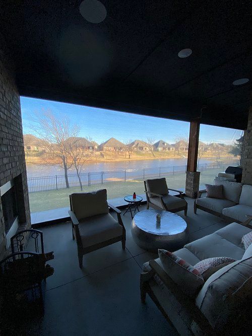 A living room with a view of a lake and mountains