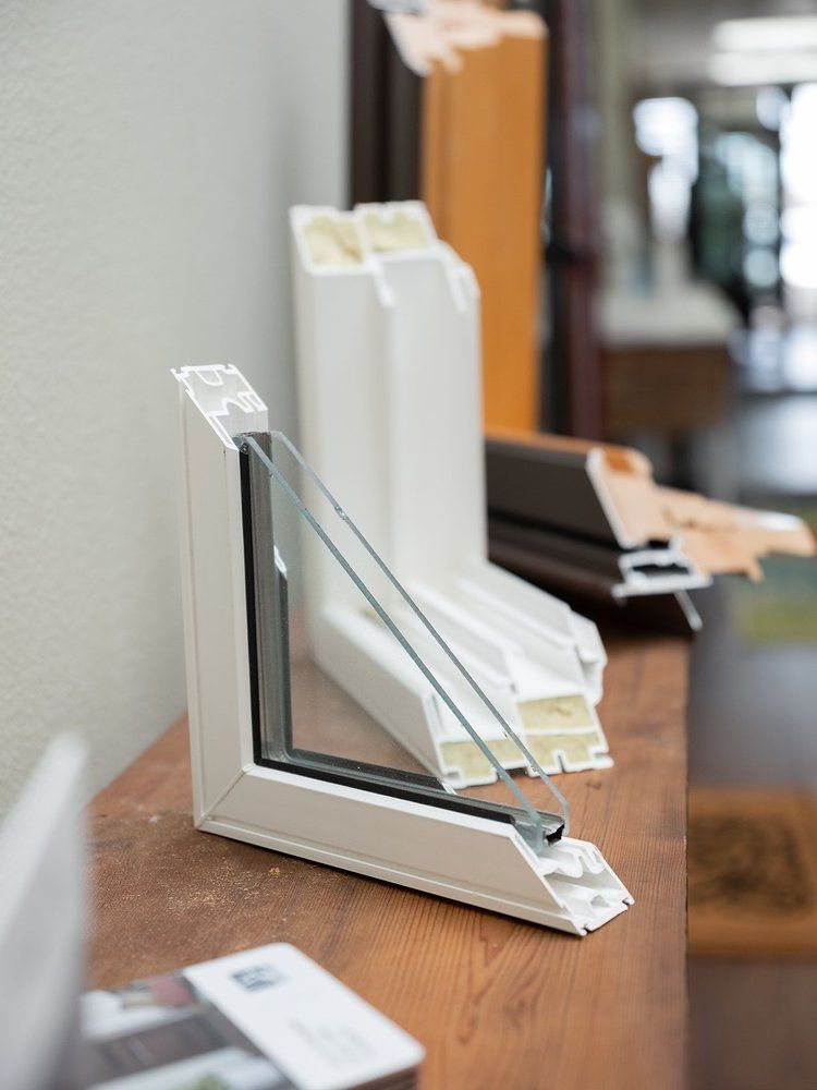 A window with three layers of glass is sitting on a wooden table.