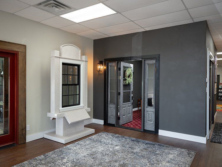 A room with a rug , a window , and a door.