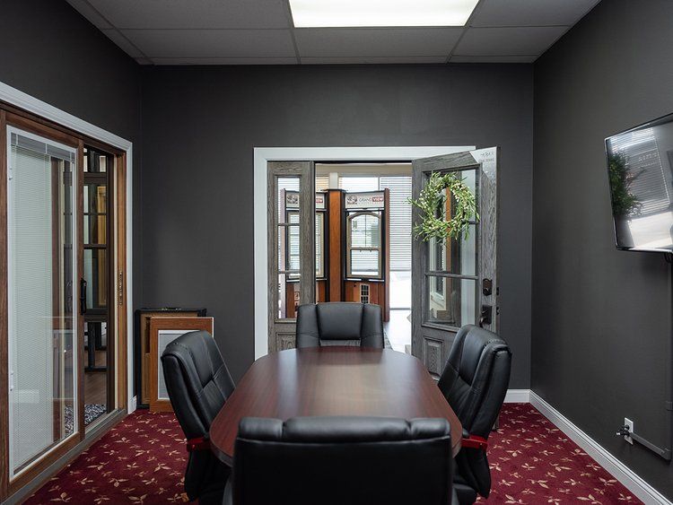 A conference room with a table and chairs in it