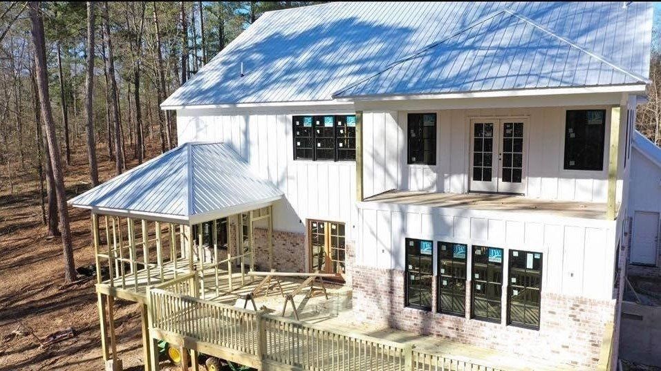 An aerial view of a house under construction in the woods.