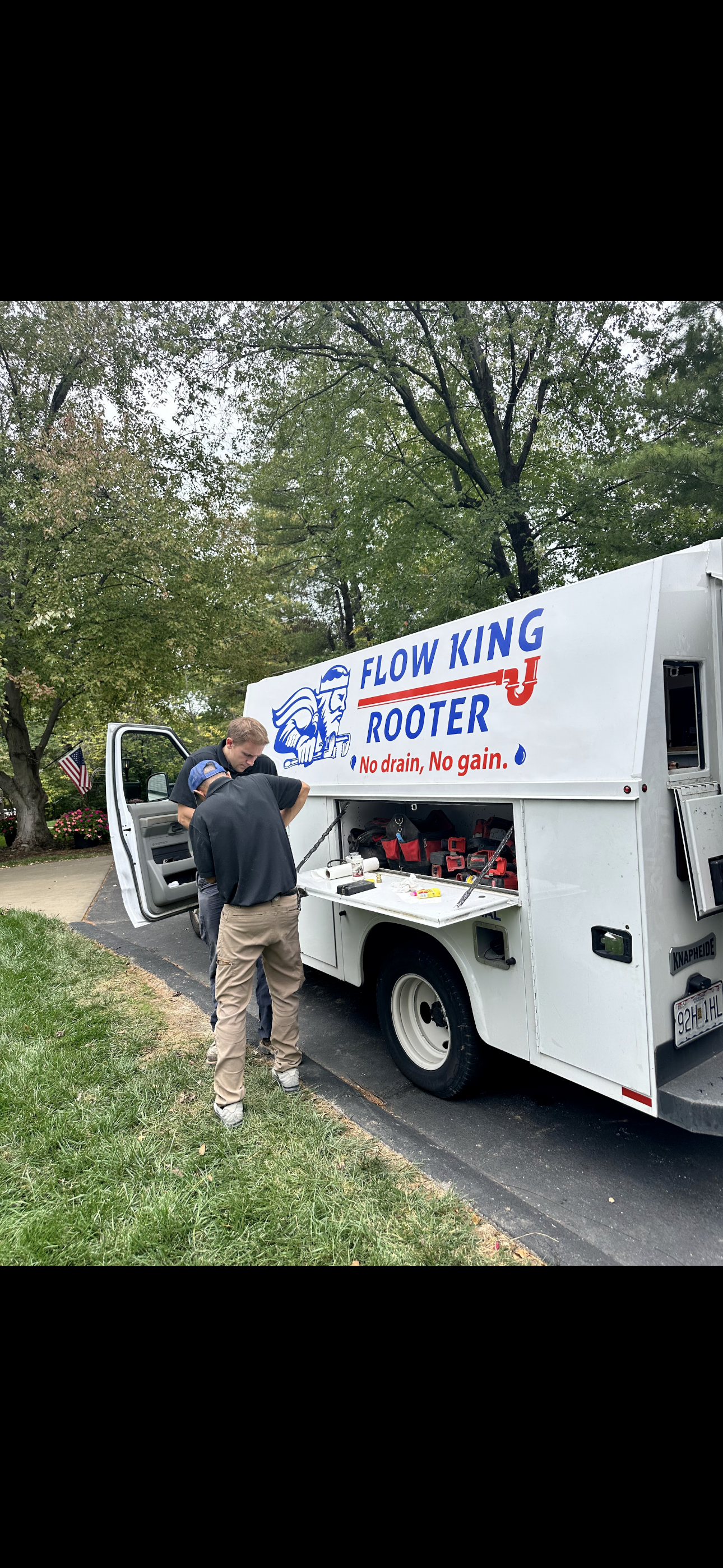 Man stands near a white work truck with 