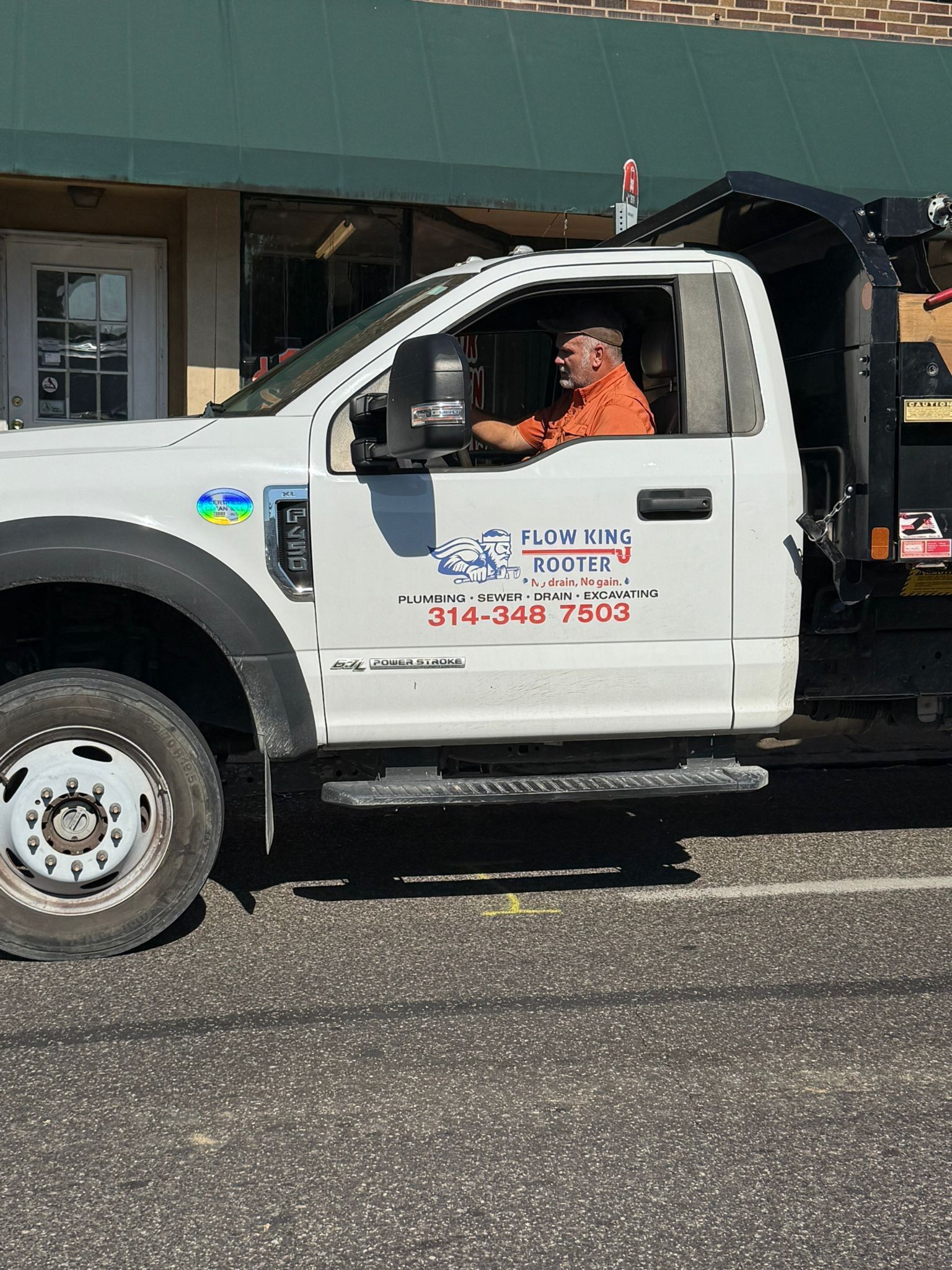 Man driving a white work truck with 