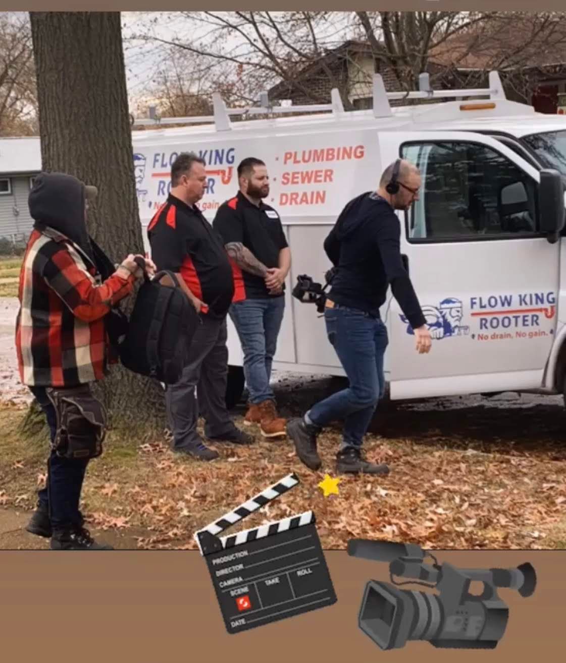 A film crew on a street. One man walks, others stand by a van labeled 