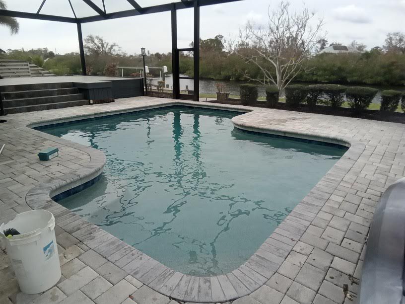 A large swimming pool with a bucket on the side of it.