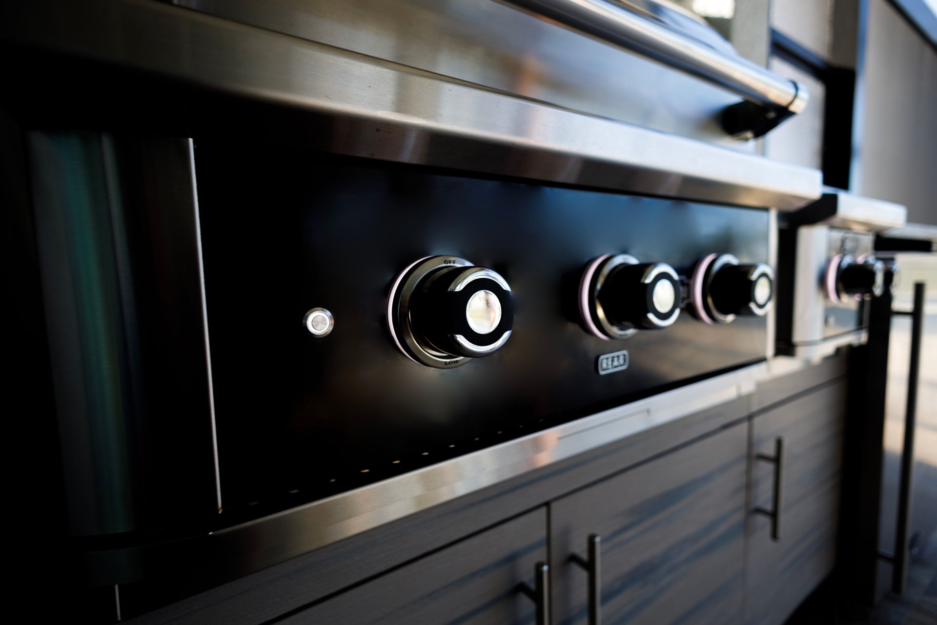 A close up of a stainless steel grill in a kitchen