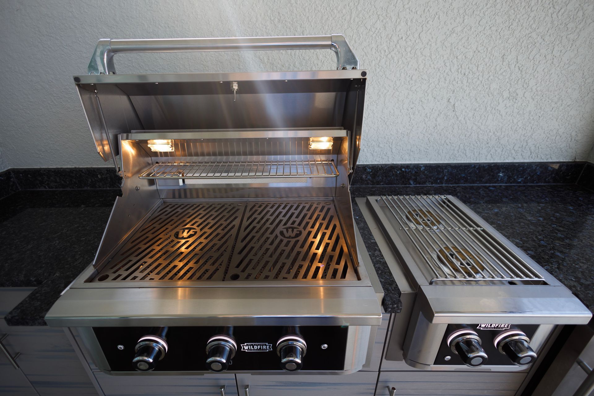 A stainless steel grill with the lid open