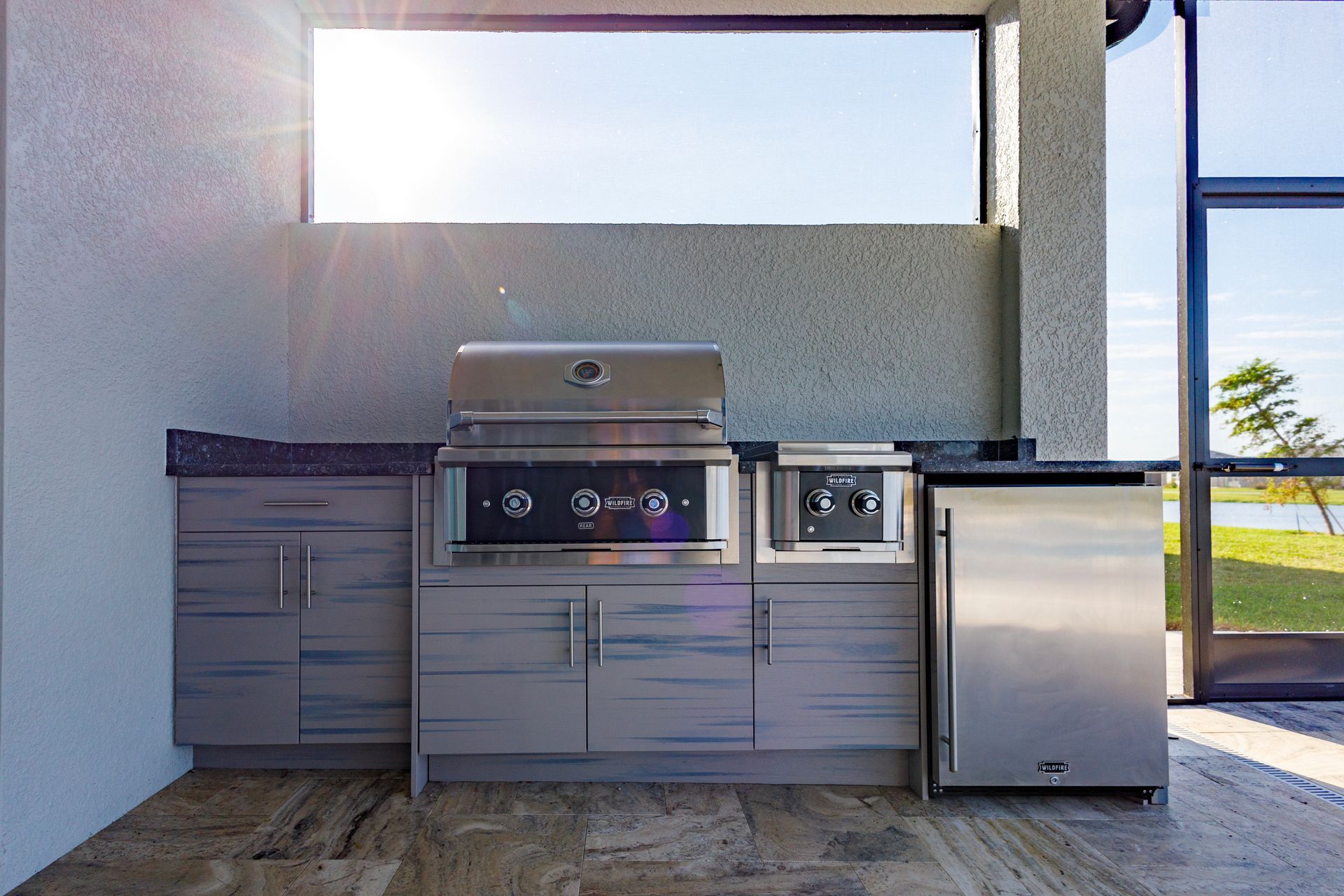 A kitchen with stainless steel appliances and a grill